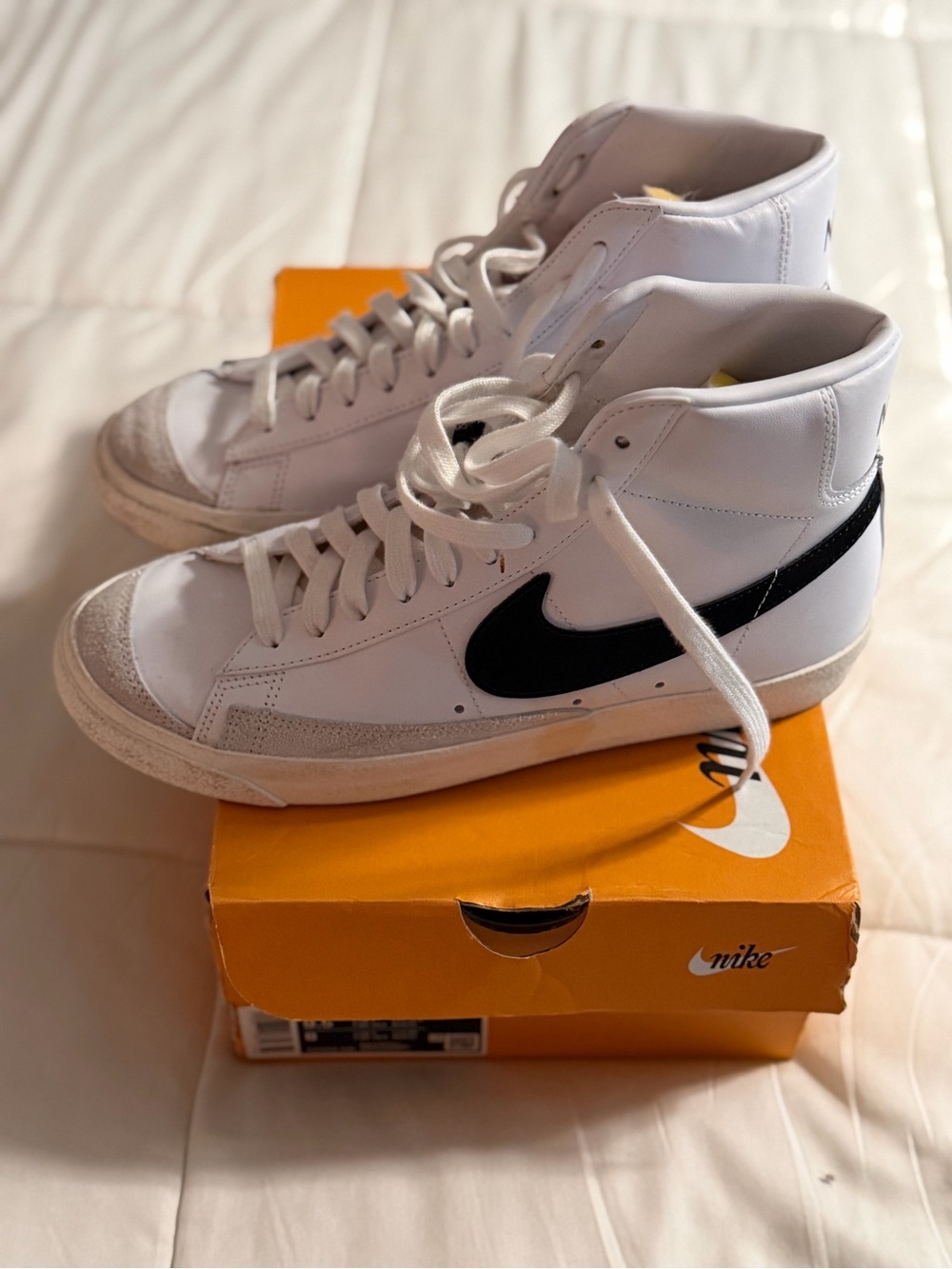 Nike White High-Top Sneakers with Black Swoosh